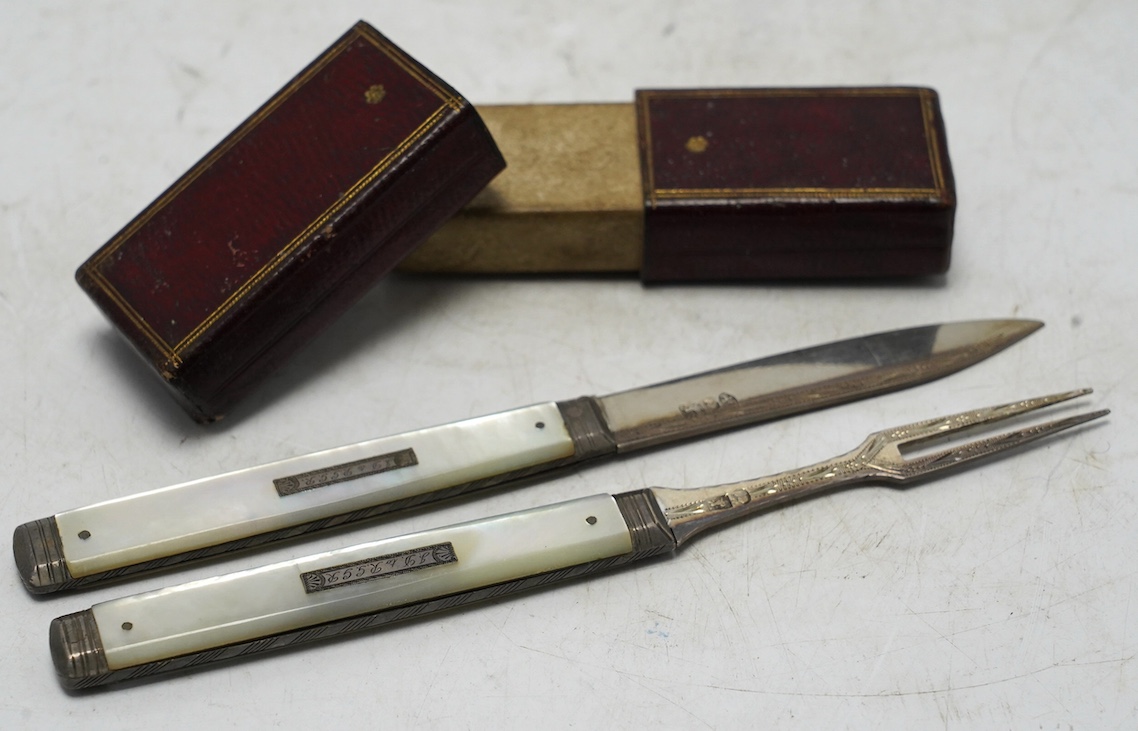 A George III mother of pearl handled silver travelling folding knife and fork, Sheffield, 1816, in original red leather case. Condition - good
